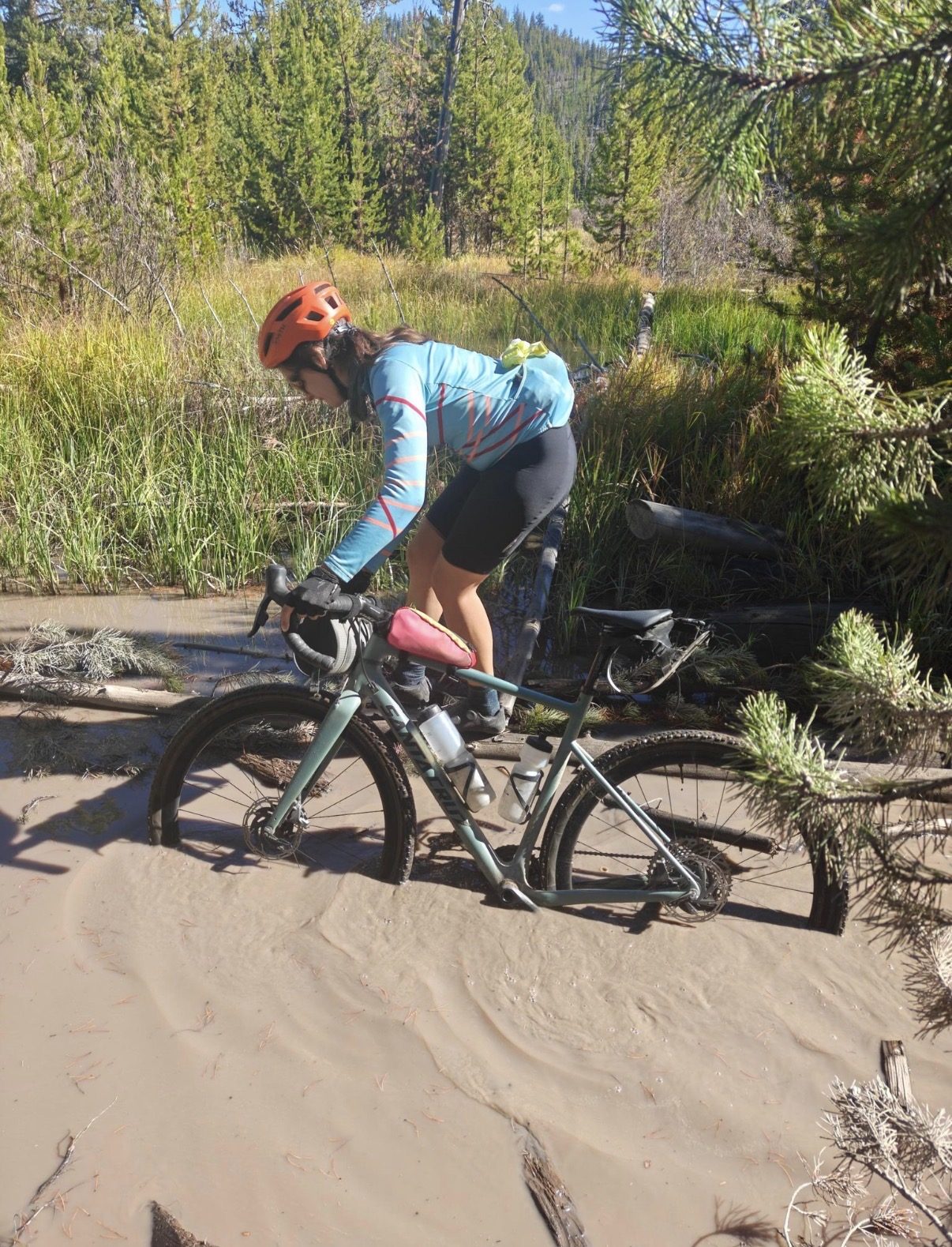 Riding through a muddy, sandy puddle